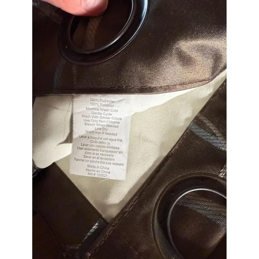 Brown curtain panels with light silver-gray circular embroidered pattern